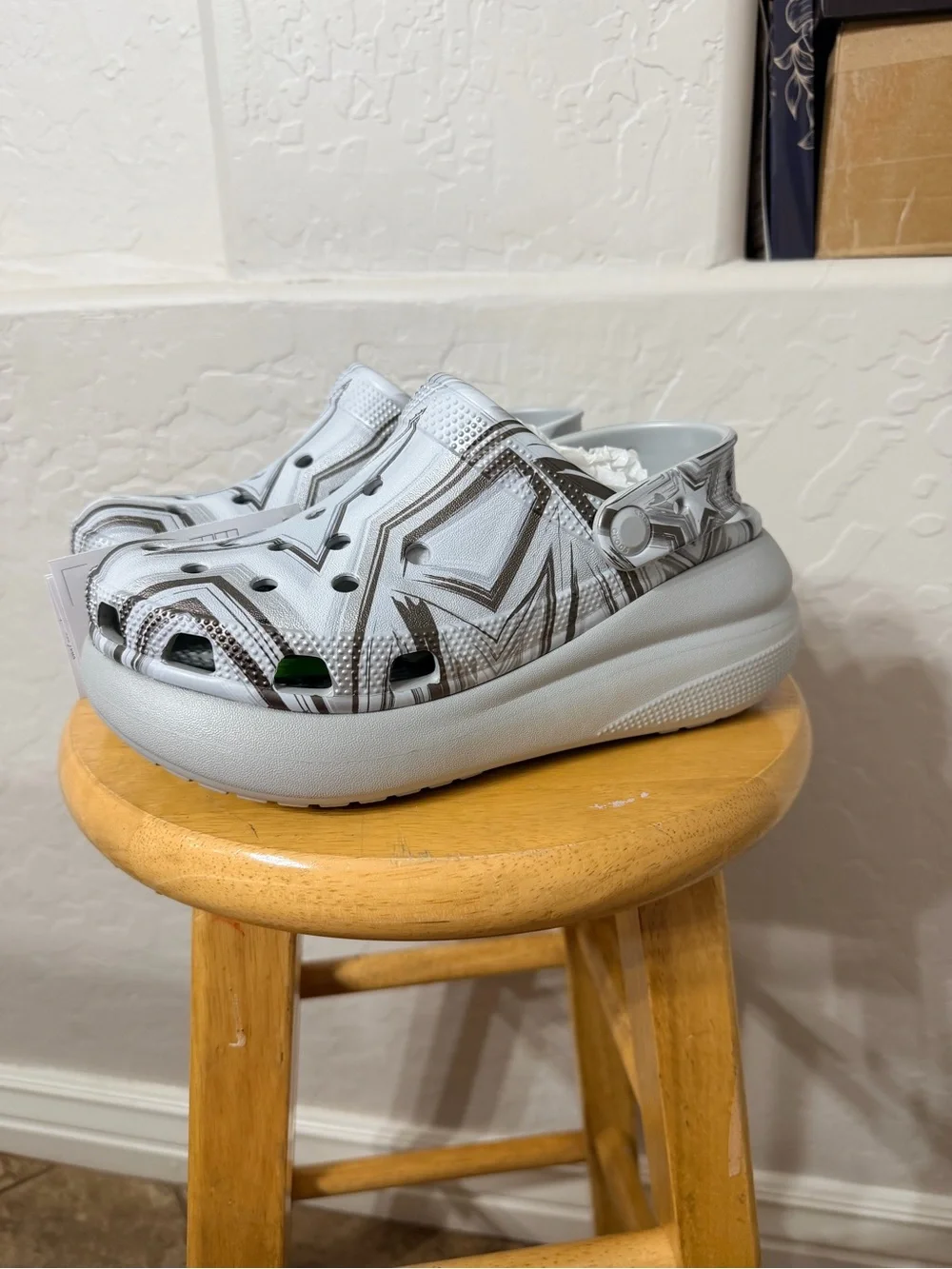 white and gray Crocs with black star and zigzag graphic size W6